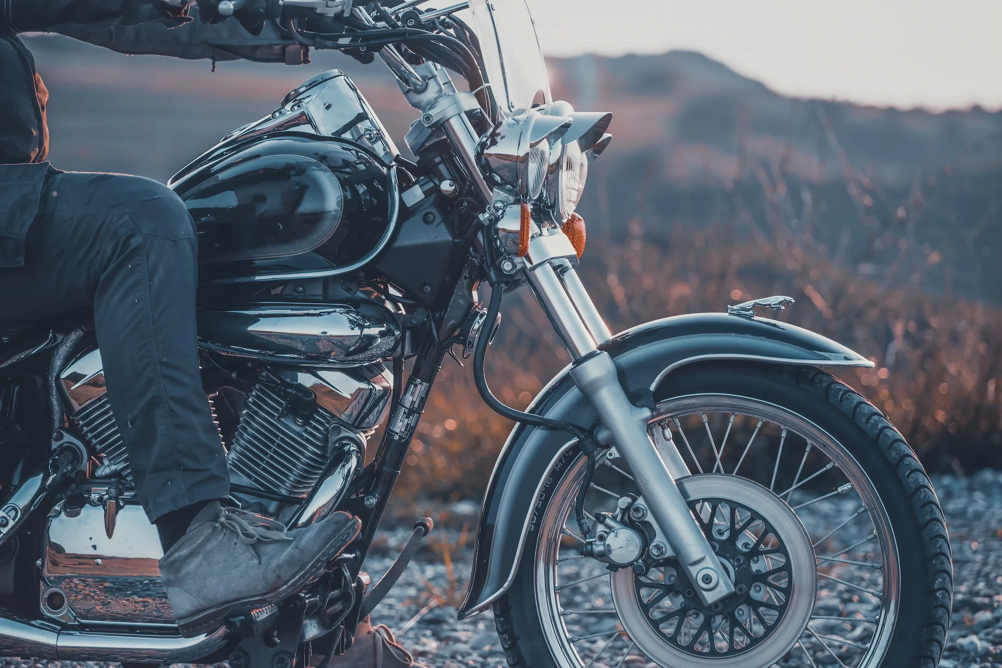 Detail of vintage motorcycle in sunset
